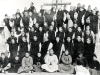 1930, Ankwo. Vincent Lebbe (back before the cross) and the Community of Little Brothers of St. John the Baptist before the wooden cross at the Monastery of the Beatitudes.   Since the beginning of 1928, Father Lebbe had undertaken a strong foundation original \"Trappists at home, apostles outside...».   [Album II Photo 115. Neg: IV 4]