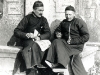 Shaohing (Chekiang), 01.1918. Fathers Anthony and Vincent Lebbe Cotta seated at a stele. and holding in his hand the I-shih-pao.   [Gallery I, Photo 46. Neg: P 19]